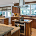 traditional kitchen island with cooktop and oven