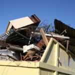 Yellow steel waste skip full of household rubbish